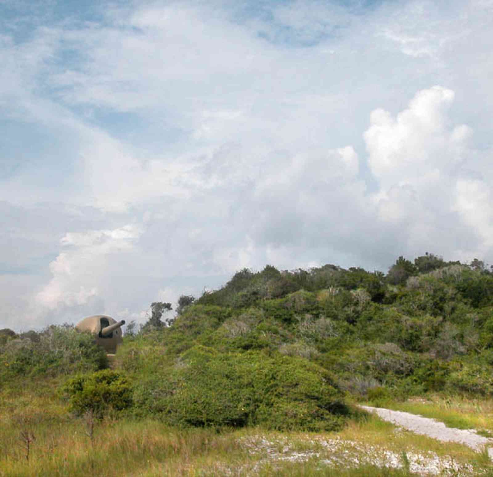 Gulf-Islands-National-Seashore:-Fort-Pickens:-Battery-234_00a.jpg:  dunes, ww-ii shield gun, emplacement, war, battle, dunes, gulf of mexico, cumulus clouds