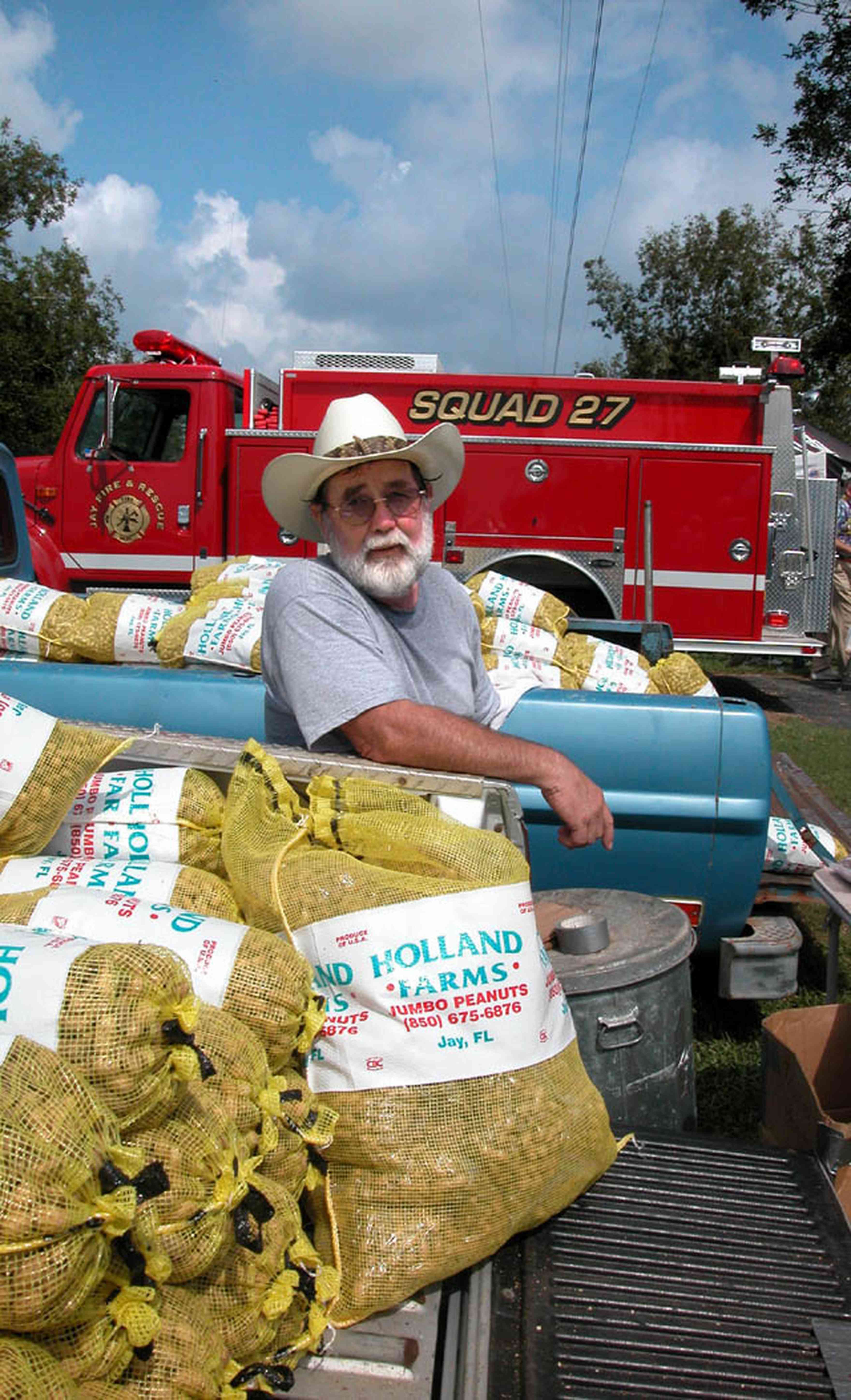 Jay:-Gabbert-Farm-Peanut-Festival_01.jpg:  tractor, john deere tractor, white fence, cows, farmland, pasture, festival, peanuts