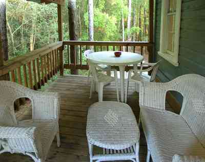 Milton:-Adventures-Unlimited_29.jpg Milton:-Adventures-Unlimited_29.jpg: wicker furniture, back porch, creek