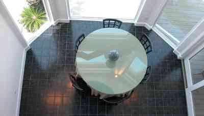 Navarre:-7332-Grand-Navarre-Blvd_12.jpg:  dining room, art deco decor, marble floor, sego palm, deck, dining room table