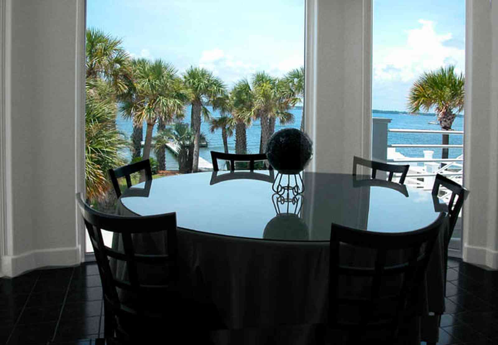 Navarre:-7332-Grand-Navarre-Blvd_13.jpg:  window view, santa rosa sound, palm tree, dining room table, art deco house, glass table