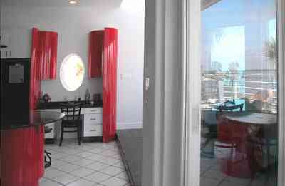 Navarre:-7332-Grand-Navarre-Blvd_14.jpg:  red lacquer cabinets, red and black, art deco decor, art deco house, kitchen, red kitchen cabinets, black laquer cabinets