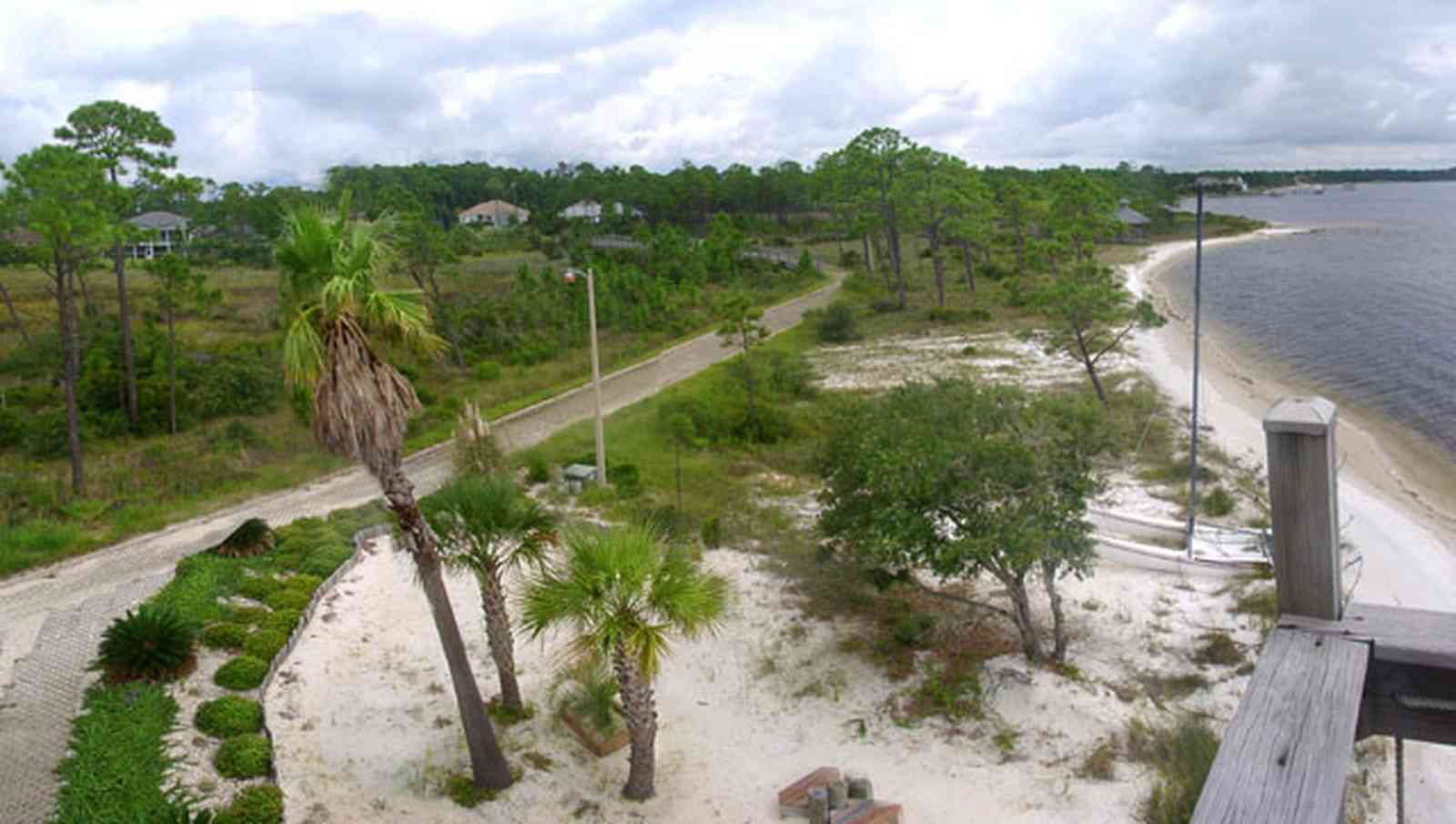 Navarre:-Biscayne-Pointe-Drive-House_12.jpg:  wetland, escambia bay, palm tree, sand shore pine tree, house deck, bridge