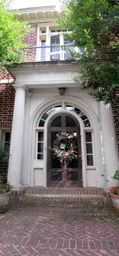 North-Hill:-105-West-Gonzales-Street_020c.jpg:  columns, french colonial architecture, brick sidewalk, geraniums, tile roof