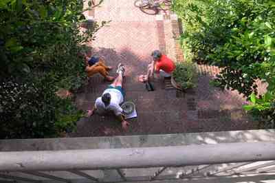 North-Hill:-105-West-Gonzales-Street_02c.jpg:  columns, french colonial architecture, brick sidewalk, geraniums, tile roof