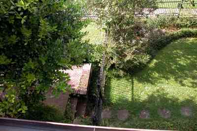 North-Hill:-105-West-Gonzales-Street_03.jpg:  balcony, porch, oak tree, wrought-iron fence, brick patio, stepping stones