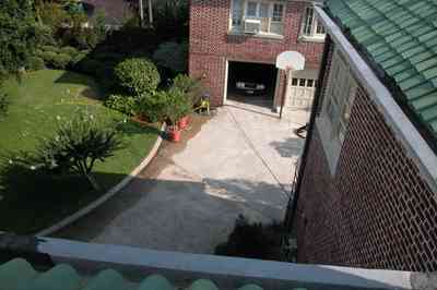 North-Hill:-105-West-Gonzales-Street_10b.jpg:  red brick house, fireplace, sidewalk, wrought iron fence, green tile roof