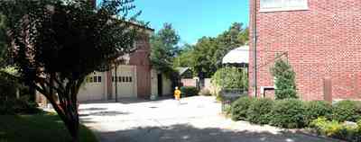 North-Hill:-105-West-Gonzales-Street_10c.jpg:  red brick house, carriage house, garage, crepe myrtle tree, french colonial architecture