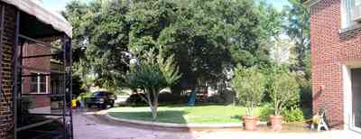 North-Hill:-105-West-Gonzales-Street_20.jpg:  driveway, red brick house, garage door, mud room, crepe myrtle tree, oak tree