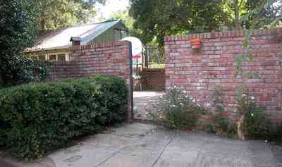 North-Hill:-105-West-Gonzales-Street_20b.jpg:  greenhouse, garden house, brick wall, patio, oak tree, hedge