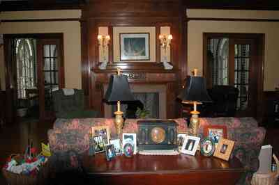 North-Hill:-105-West-Gonzales-Street_30.jpg:  grand foyer, oriental rug, spiral staircase, chandelier, hardwood floors, french colonial architecture