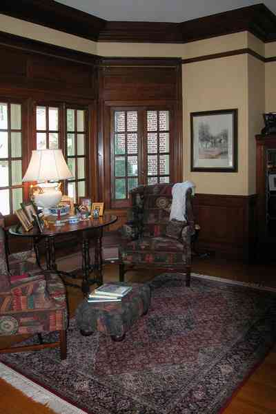 North-Hill:-105-West-Gonzales-Street_31.jpg:  grand foyer, oriental rug, spiral staircase, chandelier, hardwood floors, french colonial architecture, bay window, setee, ottoman