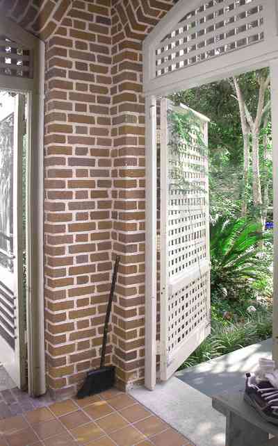 North-Hill:-105-West-Gonzales-Street_50.jpg:  mud room, tile floor, backyard, red brick house