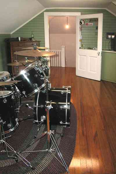 North-Hill:-105-West-Gonzales-Street_67.jpg:  attic bedroom, hooked rug, drum set, dormer room, hardwood floor