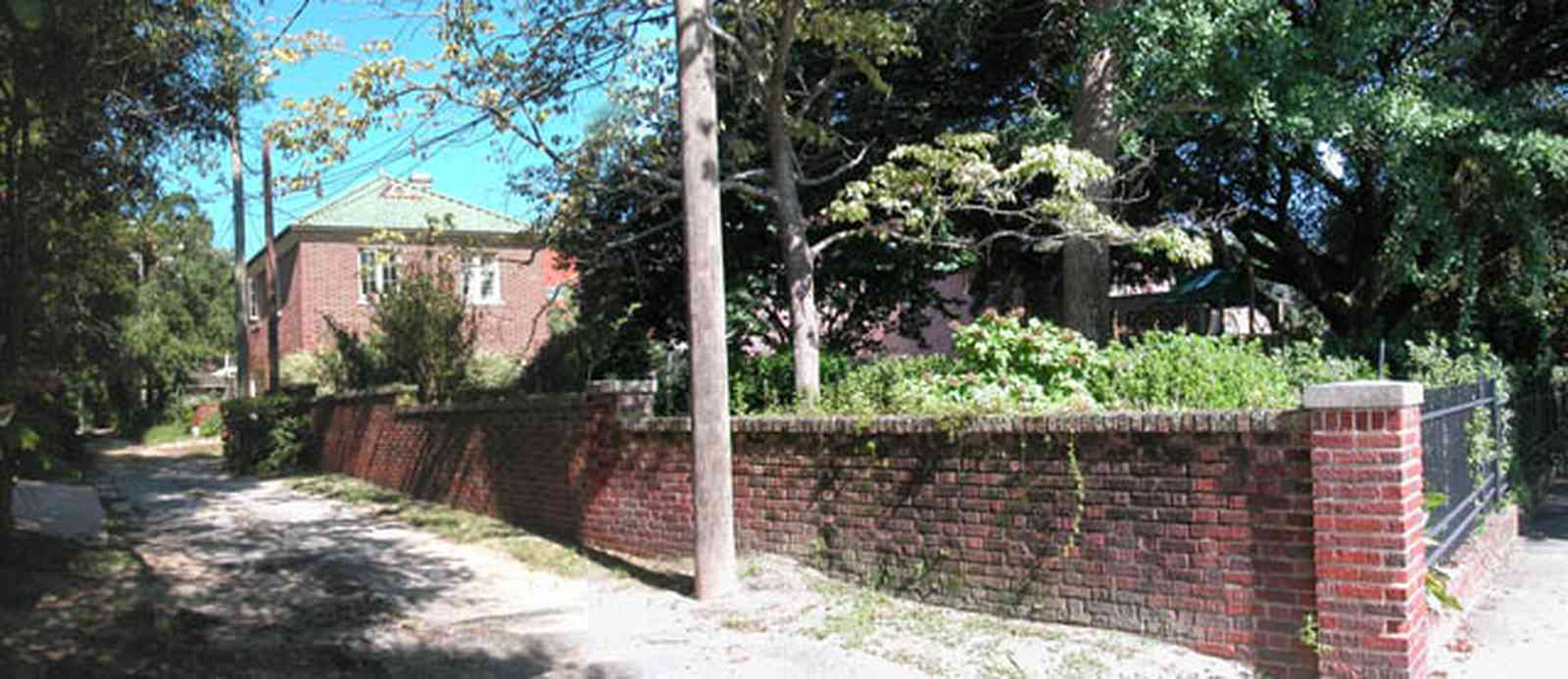 North-Hill:-105-West-Gonzales-Street_70.jpg:  service alley, brick fence, retaining wall, telephone lines, carriage house, garage, oak tree