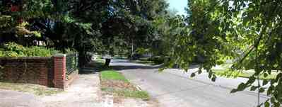 North-Hill:-105-West-Gonzales-Street_72.jpg:  brick fence, wrought iron fence, oak tree, neighborhood, service alley