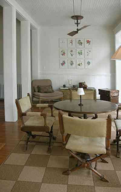 North-Hill:-116-DeSoto-St_13.jpg:  sunroom, ceiling fan, grass rug, heartpine floor