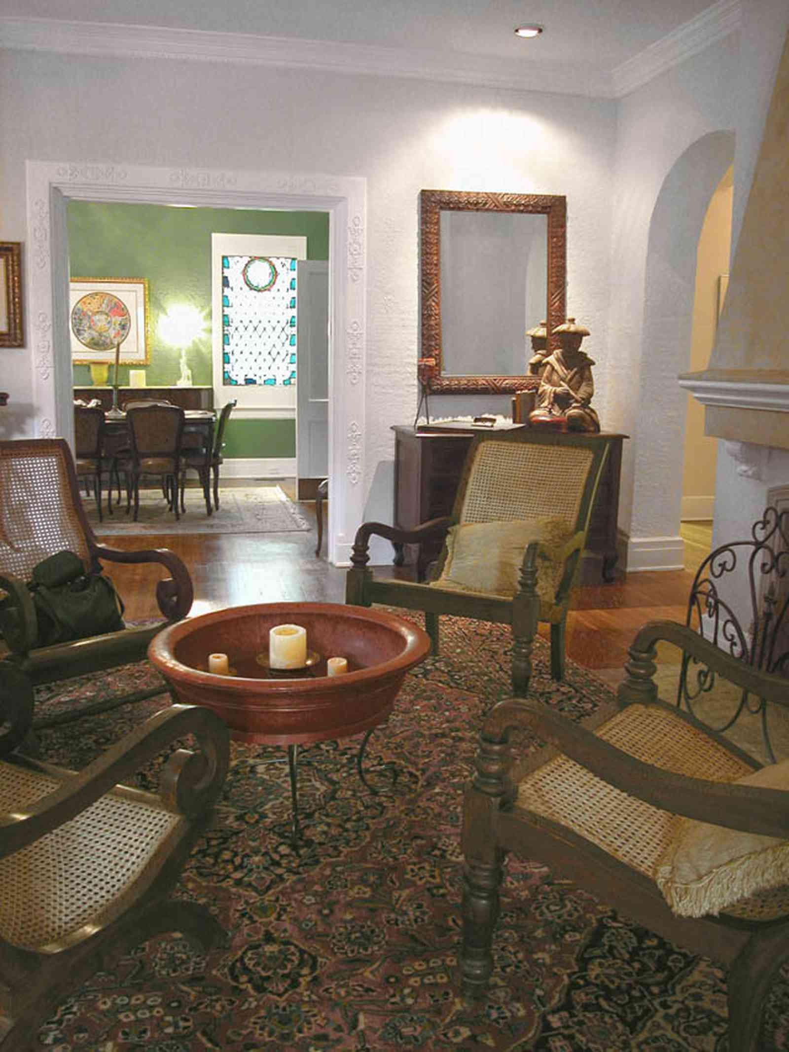 North-Hill:-123-West-Lloyd-Street_08.jpg:  chinese rice bowl, oriental rug, living room, dining room, fireplace, mantle, stucco, mirror, rocking chair