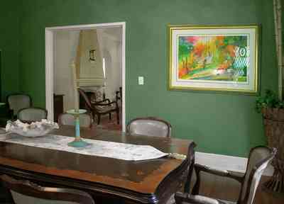 North-Hill:-123-West-Lloyd-Street_16.jpg:  dining room, formal dining room, fireplace, mantel, candlestick, conch shell, heart pine floors