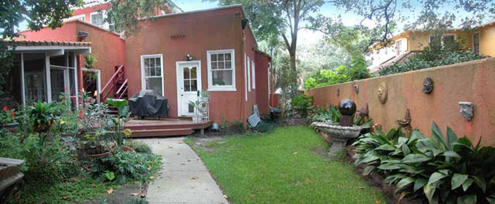 North-Hill:-123-West-Lloyd-Street_28.jpg:  stucco walls, garden, backyard, fountain, screened porch, deck, porch, italienate style