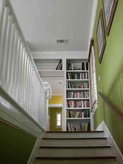 North-Hill:-123-West-Lloyd-Street_36.jpg:  stairs, master bedroom suite, railing, bannister, bookcase, library, handrail, 