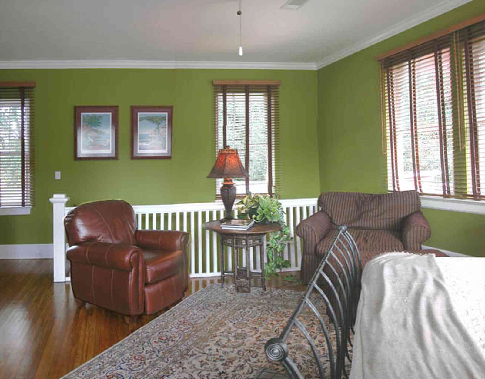 North-Hill:-123-West-Lloyd-Street_37.jpg:  leather chair, oriental rug, bed, wrought iron, venitian blinds, staircase, master bedroom suite