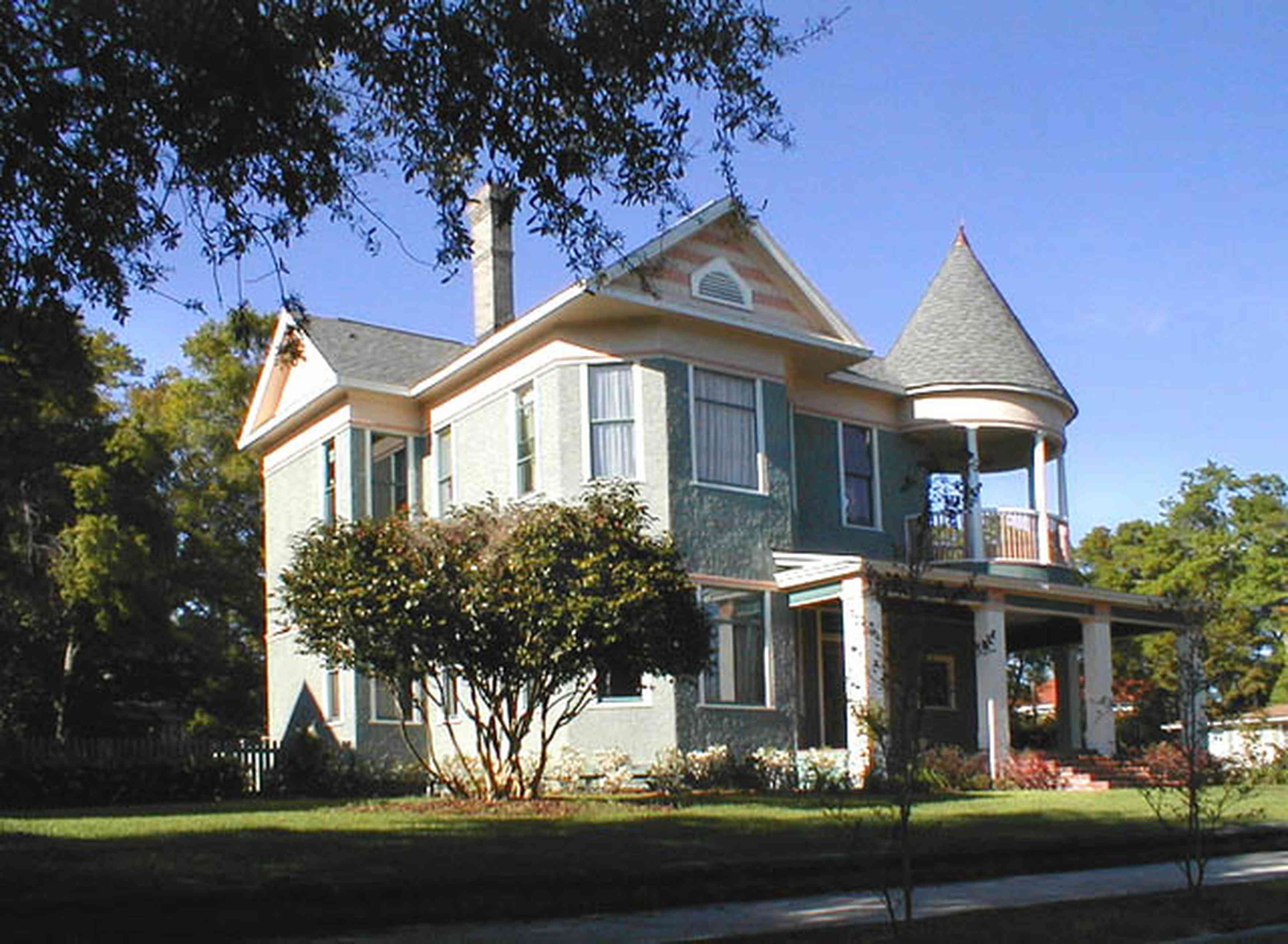 North-Hill:-200-West-Gonzales-Street_01.jpg:  gable, turret, stucco, camellia bush, front porch, oak tree, azalea bush, 