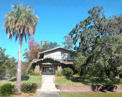 North-Hill:-284-West-Gonzales-Street_06.jpg:  craftsman cottage, rough brick facade, oak tree, historic architecture, bungalow, exposed rafters