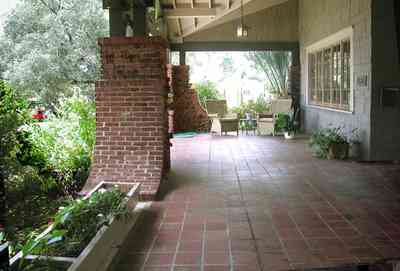 North-Hill:-284-West-Gonzales-Street_09.jpg:  craftsman cottage, planter, tile floor, shake siding, ferns