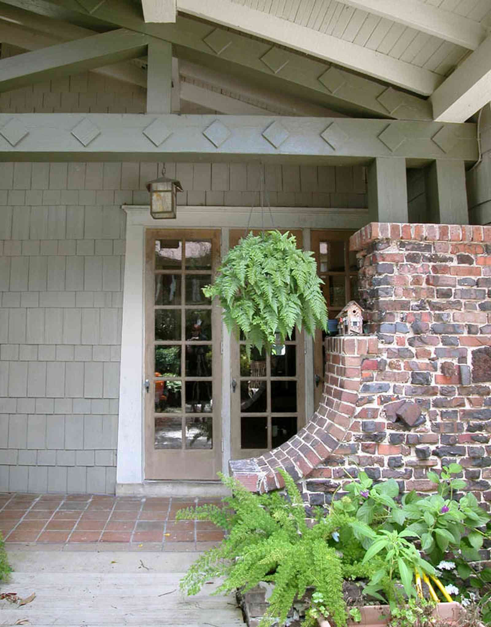 North-Hill:-284-West-Gonzales-Street_24.jpg:  side door, craftsman cottage, brick pillar, exposed beans, red tile sidewalk, ferns, birdhouse