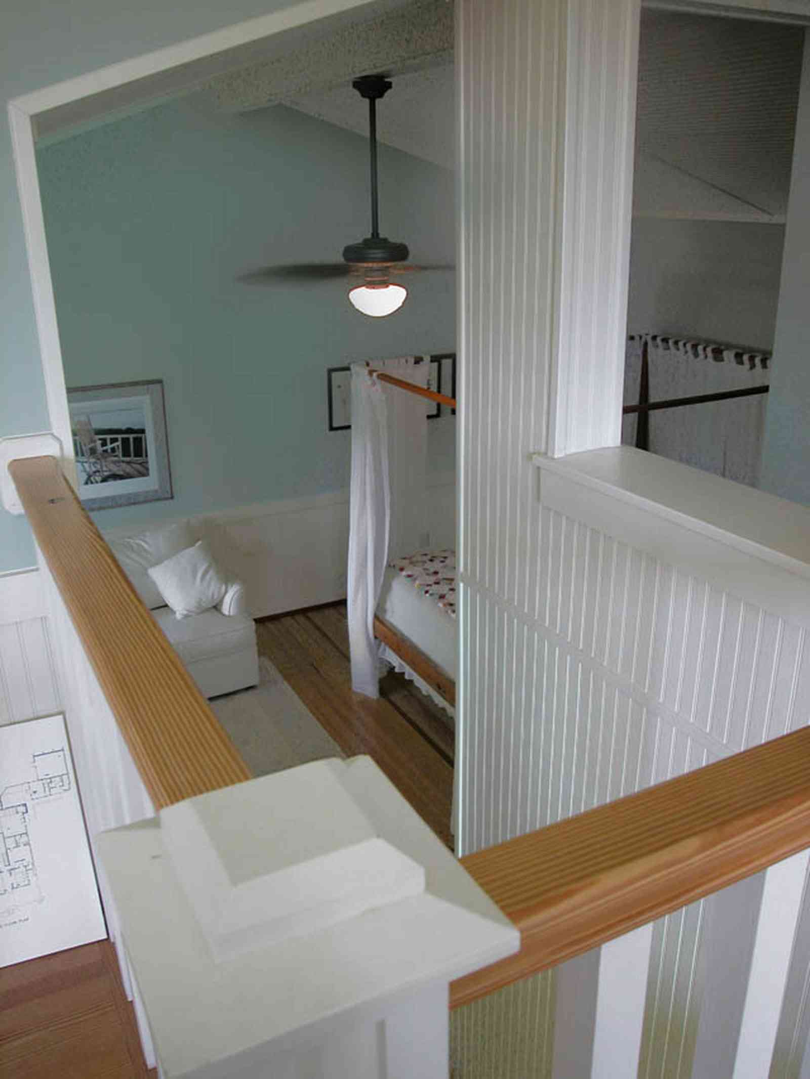North-Hill:-284-West-Gonzales-Street_27c.jpg:  canopy bed, staircase, downstairs, garage apartment, sofa, ceiling fan, wainscotting