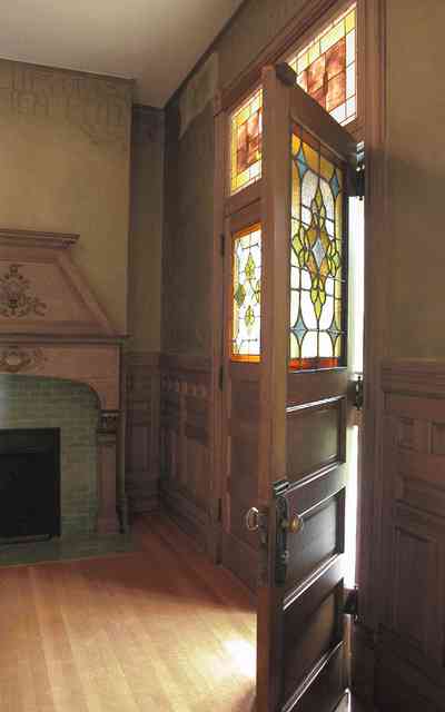 North-Hill:-304-West-Gadsden-Street_07.jpg:  carved oak mantle, stained glass transom, front door, wainscotting, heartpine flooring, north hill preservation district, faux walls stenciled borders