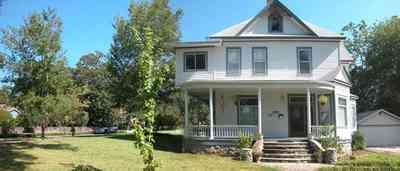 North-Hill:-52-West-Gonzalez-Street_02.jpg:  victorian home, front porch, pediment, stone staircase, casement windows, garage, queen anne architectural style