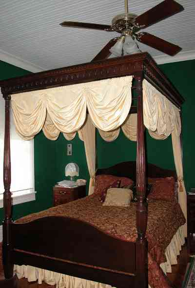 North-Hill:-52-West-Gonzalez-Street_19.jpg:  canopy bed, damask bedspread, four-poster bed, swag curtain, ceiling fan