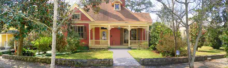 North-Hill:-Turner-Antique-Shop_01.jpg:  victorian house, gabled roof, stained glass windows, gingerbread trim, balustrade, camellia bush