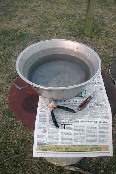 Oak-Grove:-Carpenters-Catfish-Farm_07b.jpg:  grippers, cleaning fish, fillet knife, newspaper, bowl of water, wash fish