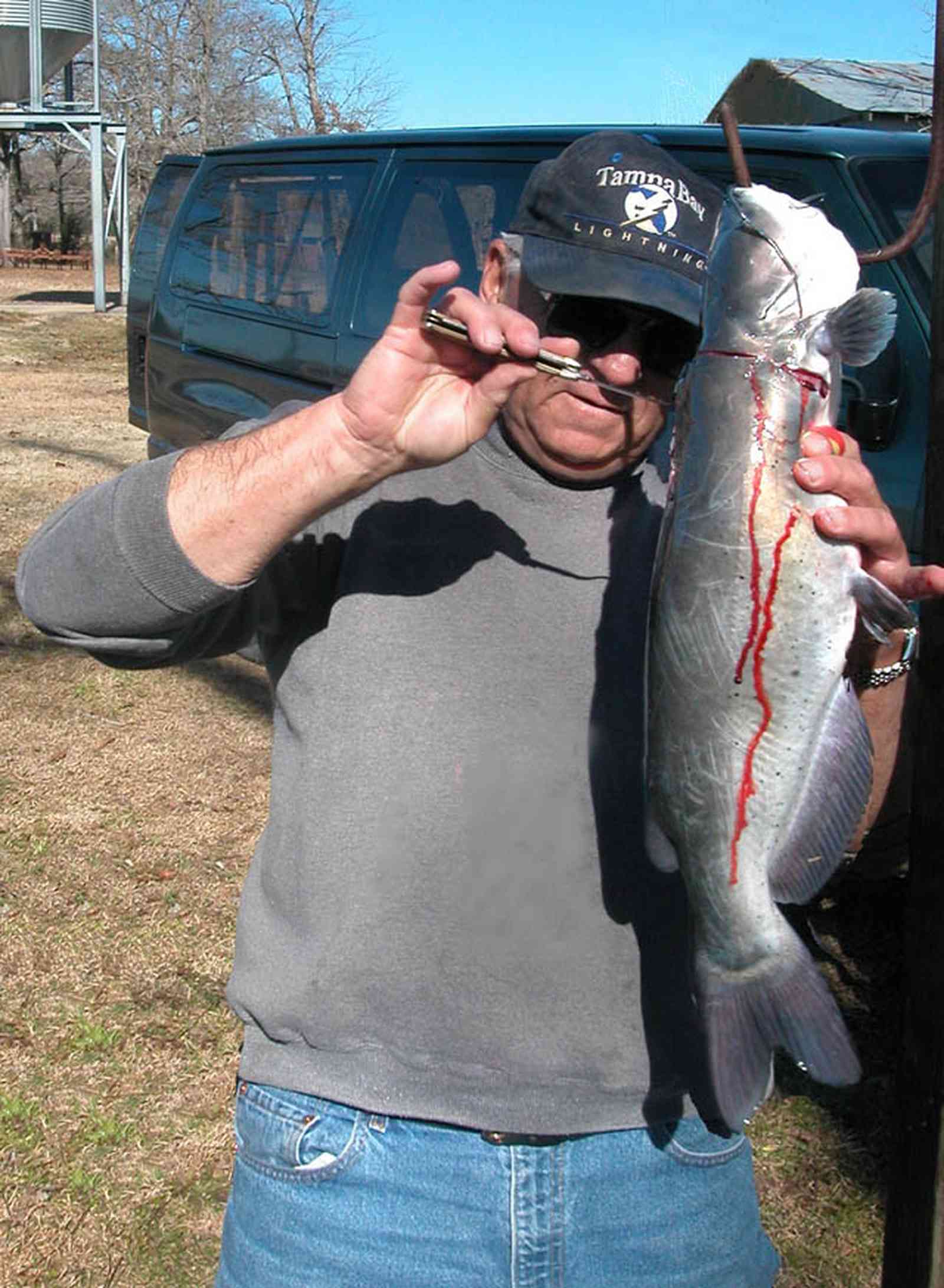 Oak-Grove:-Carpenters-Catfish-Farm_08.jpg:  catfish, cleaning catfish, knife, skinning fish, gaffing hook