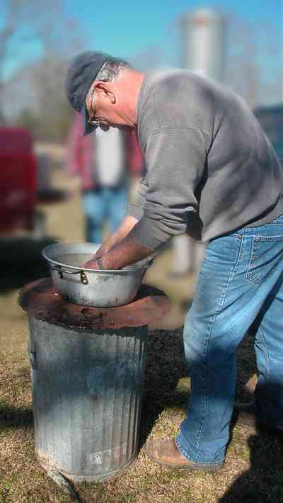 Oak-Grove:-Carpenters-Catfish-Farm_13.jpg:  washing fish, garbage can, basin of water, cleaning catfish
