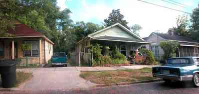 Old-East-Hill:-415-La-Rua-Street_02.jpg:  craftsman cottage, brick street, driveway, oak trees, front porch, chain link fence