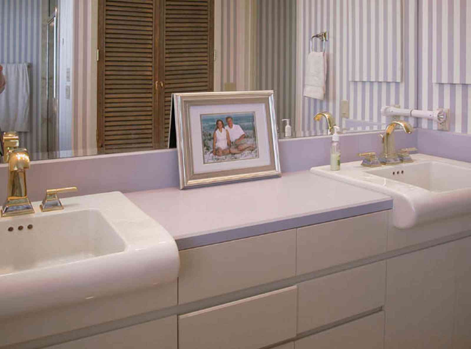 Pensacola-Beach:-1212-Ariola-Drive_12.jpg:  master bathroom, louvered door, striped wallpaper, beach house, framed family portrait