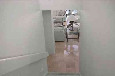 Pensacola-Beach:-1212-Ariola-Drive_14.jpg:  travitine marble floor, staircase, lamp, living room