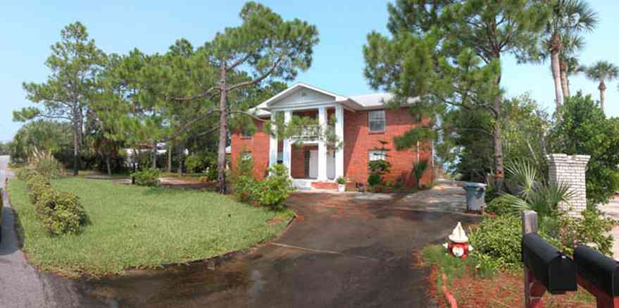 Pensacola-Beach:-235-Sabine-Drive_01.jpg:  colonial architecture, columns, red brick house, pine trees, long-leaf pines, circular driveway
