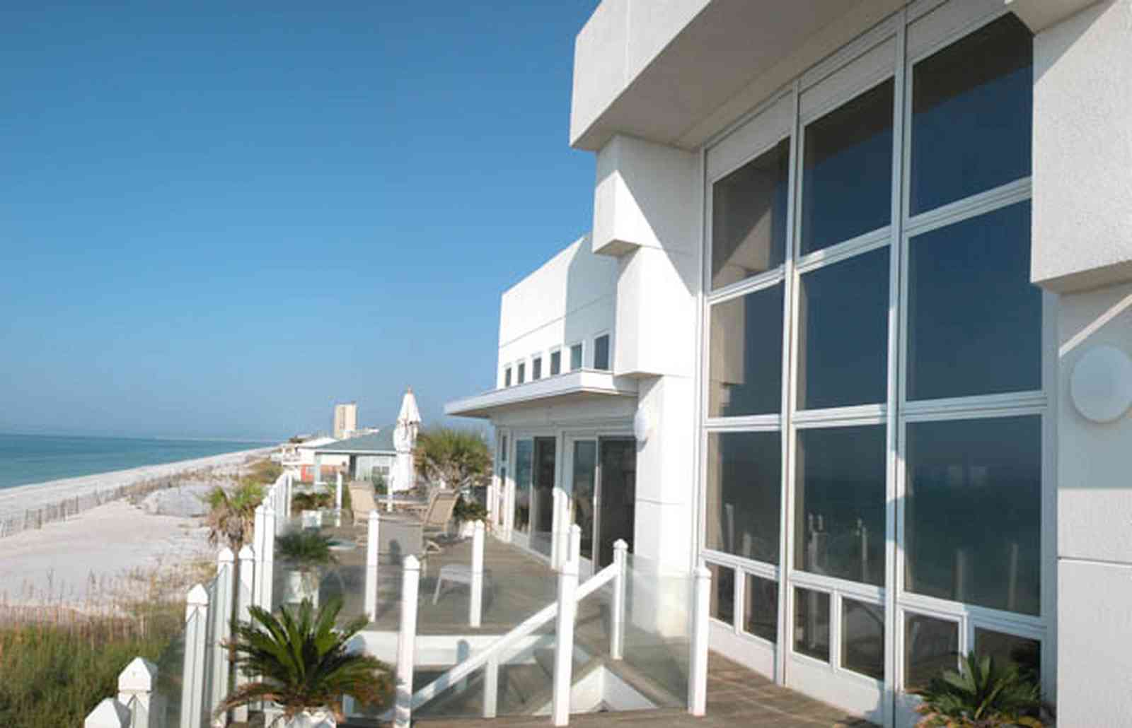 Pensacola-Beach:-Ariola-Drive-Art-Deco-House_07.jpg:  sand, crystal sand, white sand, sugar sand, sea oats, bauhaus architectural style, palm trees, dune restoration, porch, deck, glass railing, beachfront property