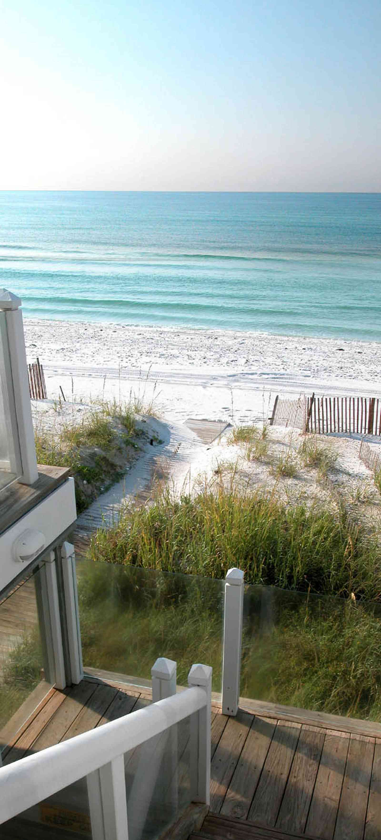 Pensacola-Beach:-Ariola-Drive-Art-Deco-House_09a.jpg:  glass balcony, sea grass, sea oats, dune, boardwalk, deck, porch, staircase, gulf of mexico, beach front house, emerald coast, pensacola beach, beachhouse, dune fence, crystal sand, white sand