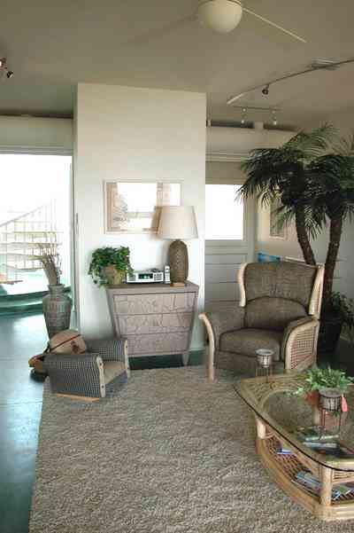 Pensacola-Beach:-Ariola-Drive-Art-Deco-House_17a.jpg:  coffee table, chairs, lamp, palm tree, circular stairs, beachfront home, geothermal heating system