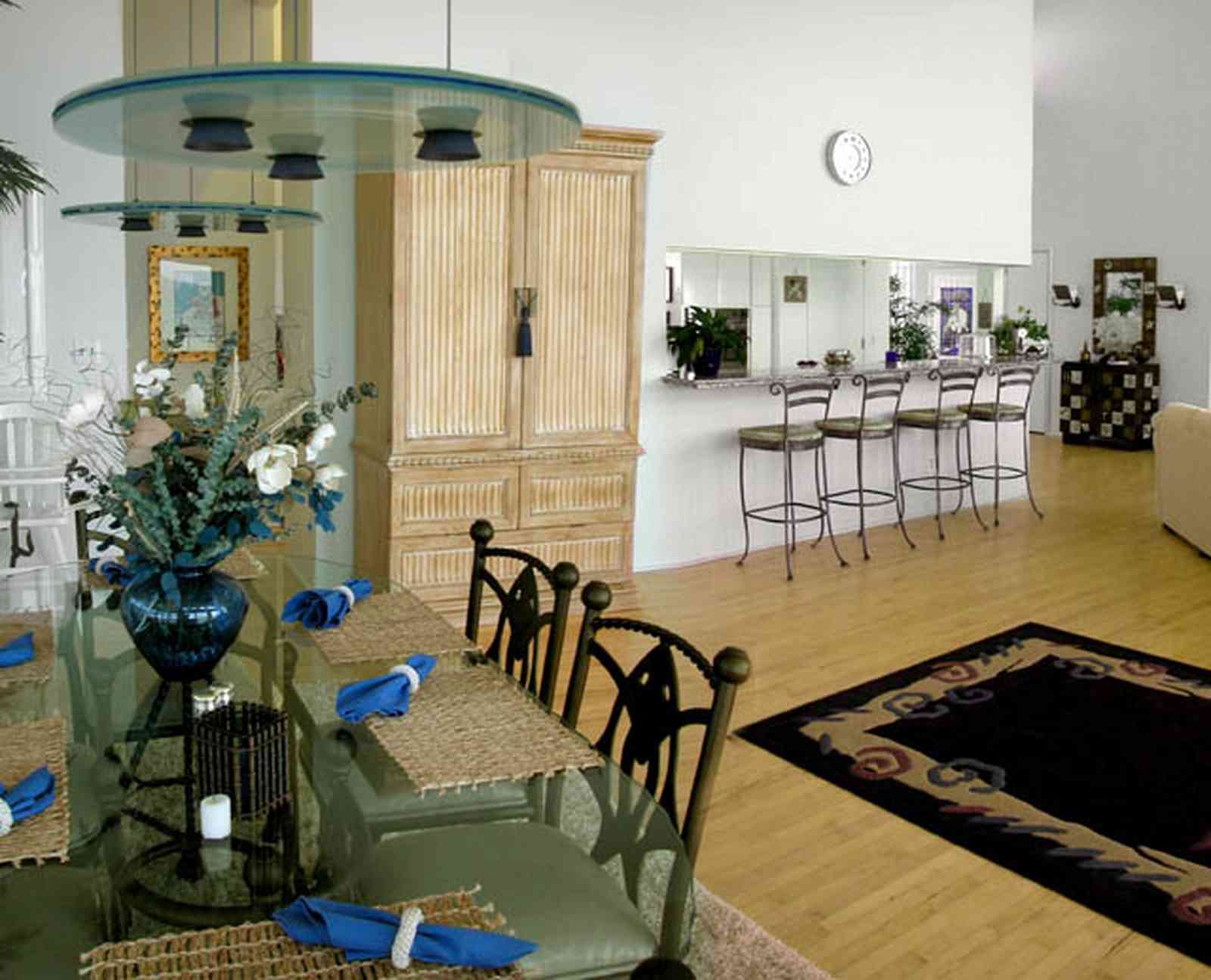 Pensacola-Beach:-Ariola-Drive-Art-Deco-House_28a.jpg:  glass table, flower arrangement, living room, dining room, beach house, kitchen stools, counter tops