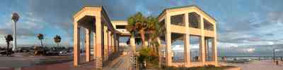 Pensacola-Beach:-Casino-Beach-Pavillion_02.jpg:  temple, beach ball, water tower, palm tree, amphitheater, beach front, surf, seating area, clearing skies, 