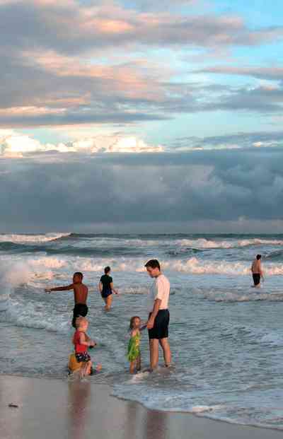 Pensacola-Beach:-Casino-Beach_01d.jpg:  surf, beach, swimmers, tropical storm, squall line, cumulus clouds, surfers, high waves, gulf of mexico
