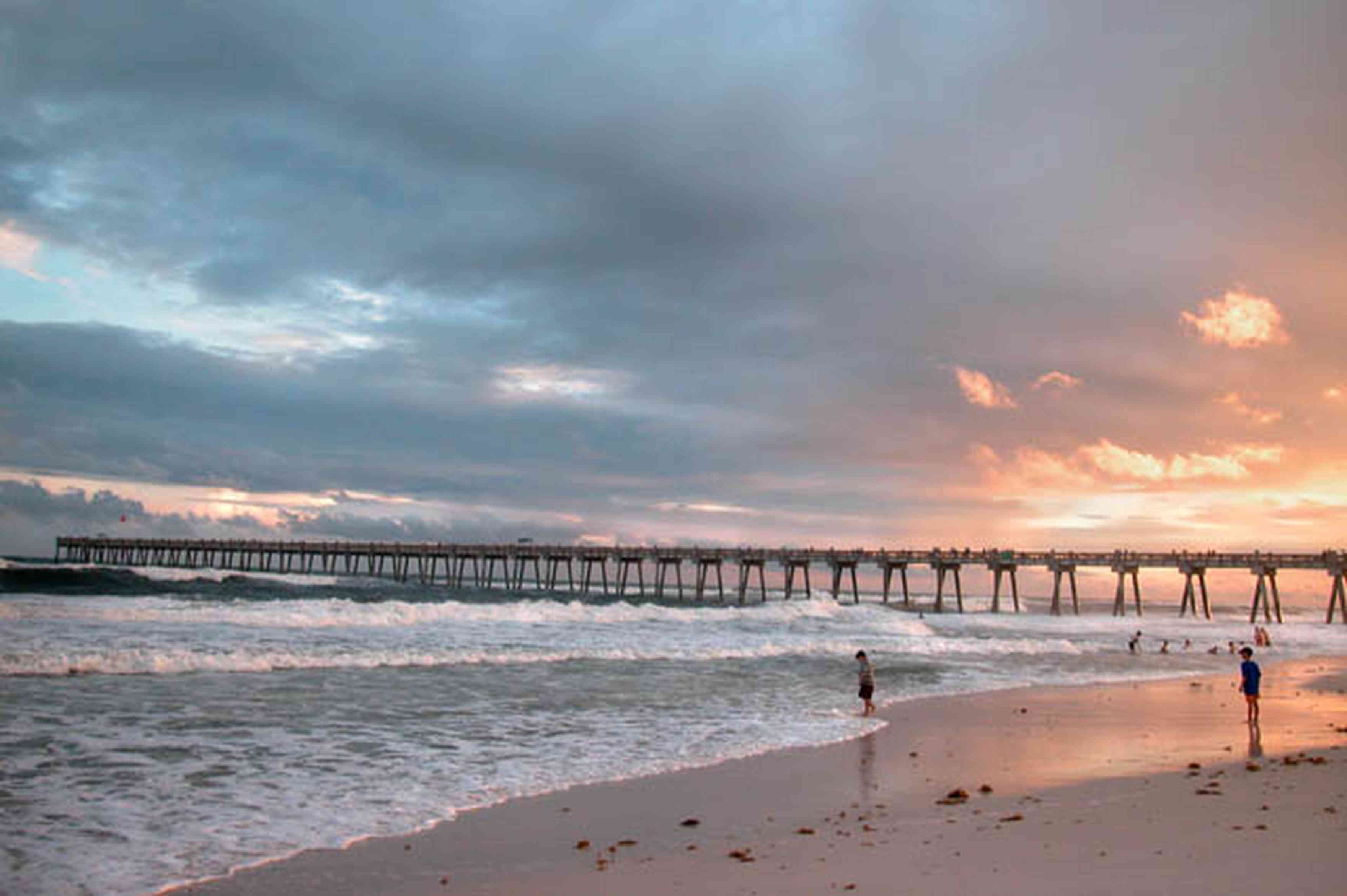 Pensacola-Beach:-Gulf-Fishing-Pier_03.jpg:  sunset, clouds, surf, surfers, sand, gulf of mexico