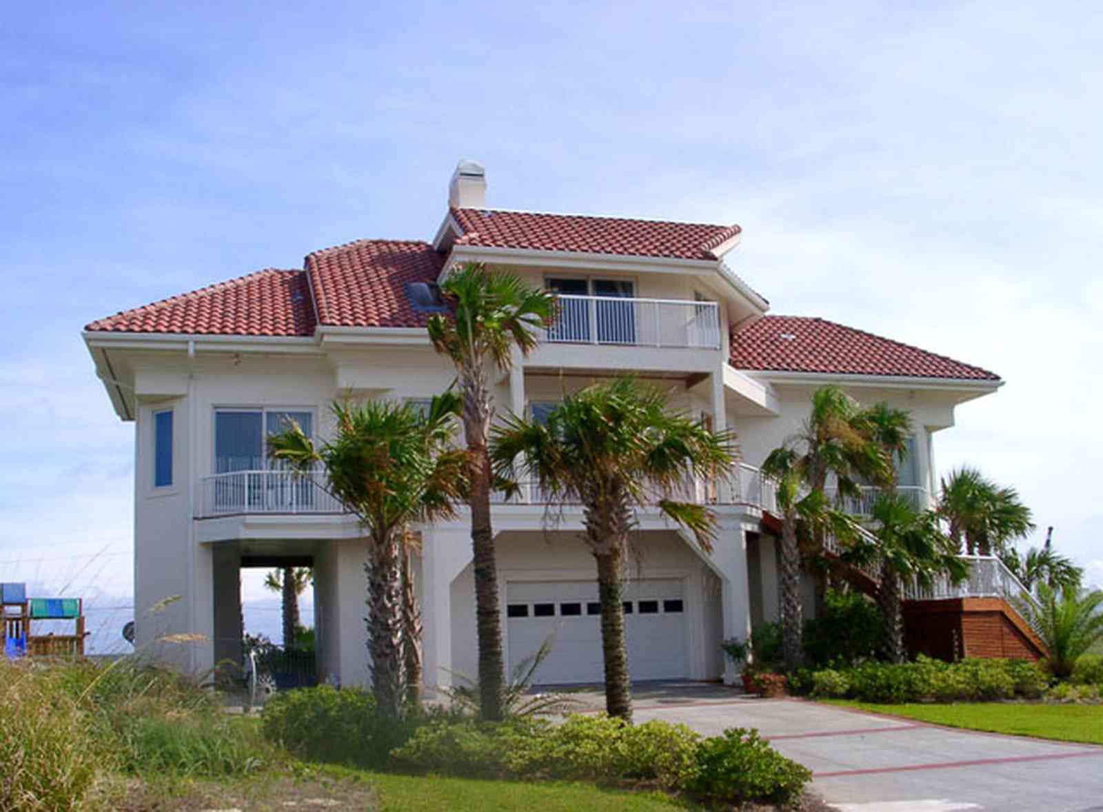 Pensacola-Beach:-Hermosa-St-Homes_13.jpg:  mediterrean villa, palm tree, gulf of mexcio, red tiled roof